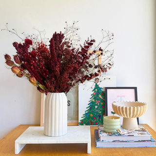 Cozy Winter dried flower arrangement in bordeaux and burgundy in a ribbed ceramic vase